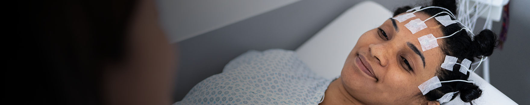 woman lying down on hospital bed