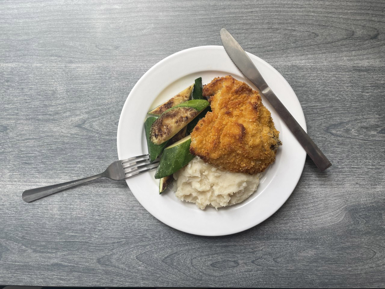 oven fried chicken with mashed potatoes and zucchini