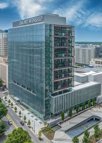 skyscraper glass building with Emory Winship lettering at the top