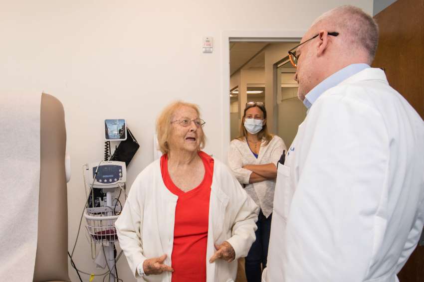 Elberta Jenkins speaks to a doctor at her check-up visit