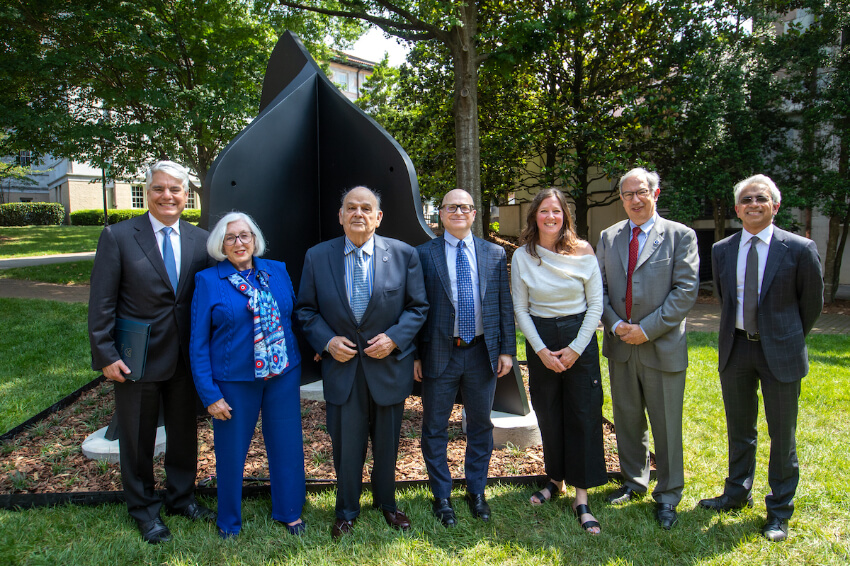 President Fenves, Rebecca and Sidney Yarbrough, David Schuster, Amy Pleasant, Carlos del Rio and Ravi Thadhani in front of “Resting Figure,” located beyond the northeast corner of the Callaway Memorial Center