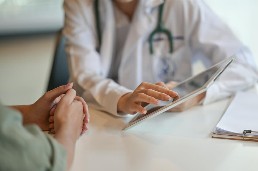 physician talking with patient in office