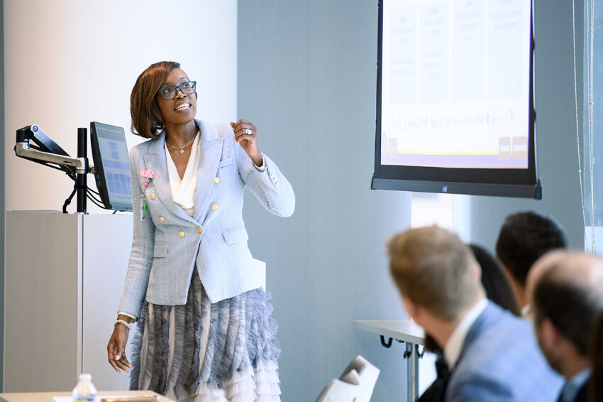 Ebonie Hardman, RN, MSN, MBA, assistant director of research informatics, presents to members of the delegation