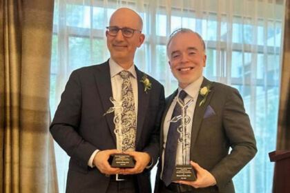 David Kooby and Dhaval Desai pose with their awards