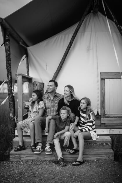 black and white photo of Jill, Bryan Wells and their three children sitting together