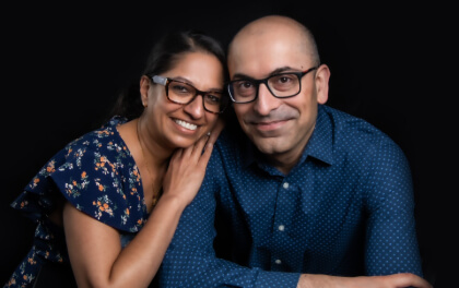 Divya leaning on Ravi's shoulder, smiling