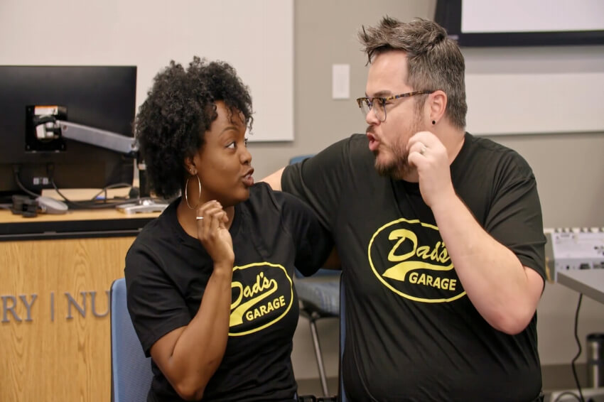 Two people performing improv