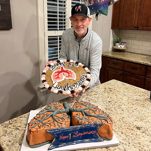 Cliff shows lung-shaped cake at his lung transplant anniversary