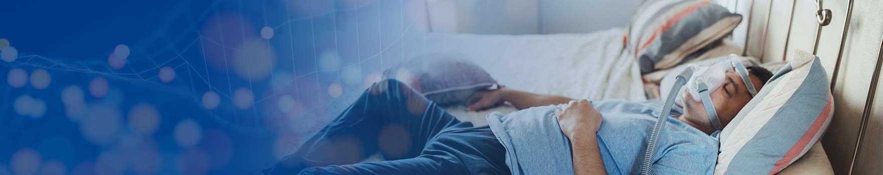 Man in bed with breathing machine attachment on his face