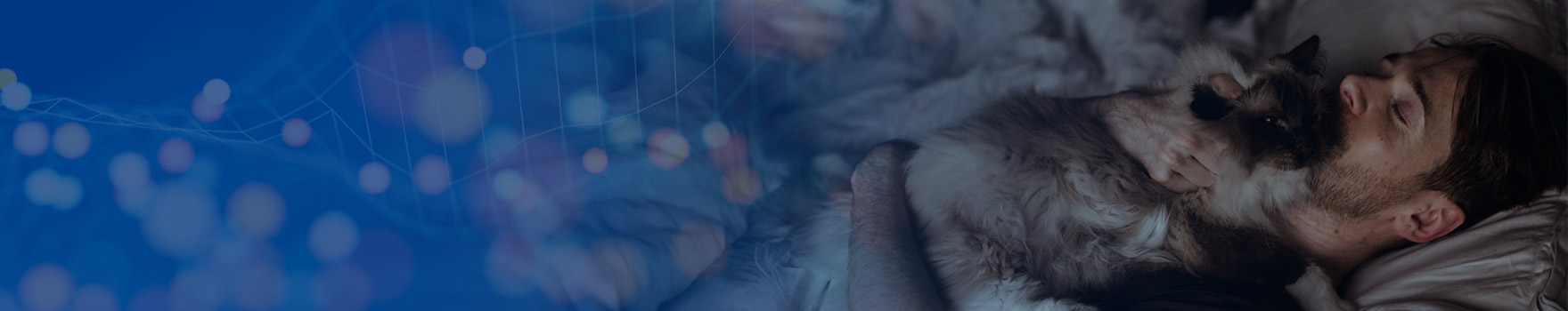 Man holding cat while trying to sleep