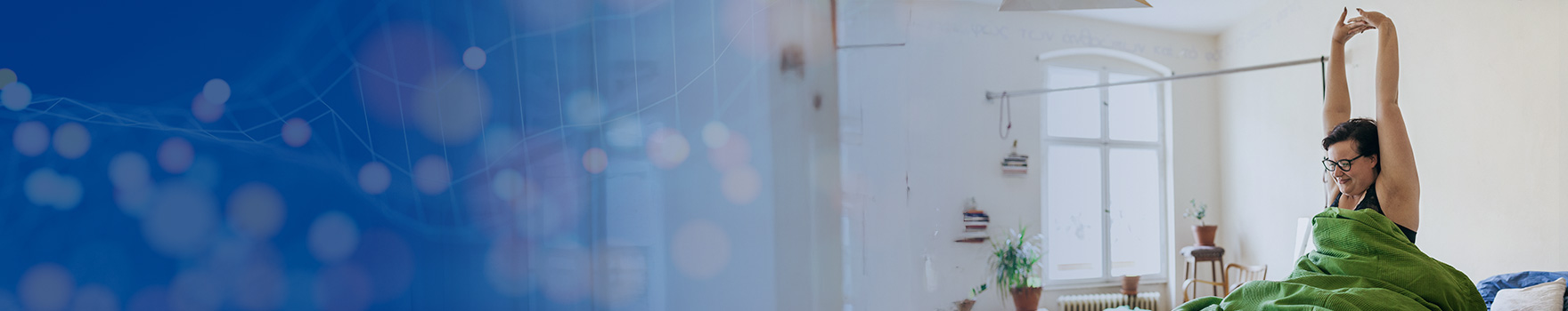 A woman gently stretches as she rises from sleep.