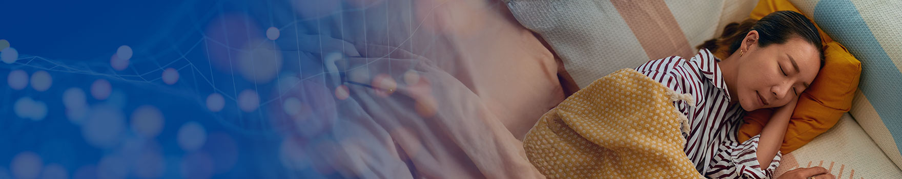 A serene woman enjoys a deep sleep, supported by a plush pillow.