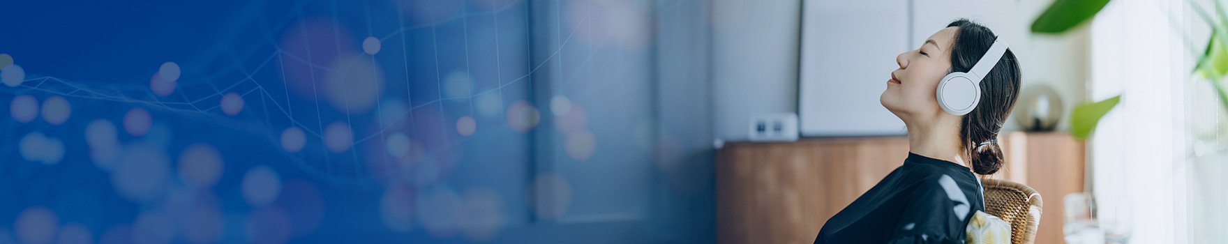 woman listening to music while resting on a chair
