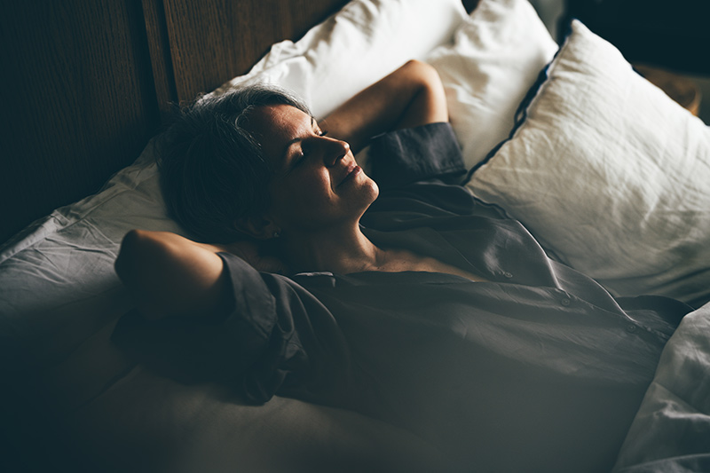Woman sleeping soundly with her head on a pillow.