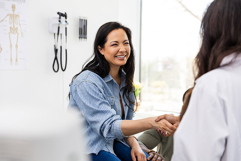 Ophthalmologist consulting with patient inside modern eye care office