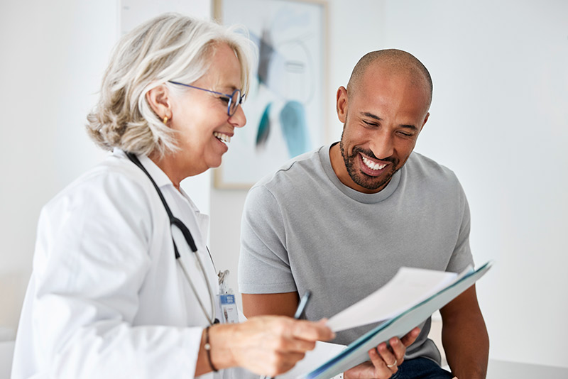 Patient listening to doctor’s explanation inside exam room