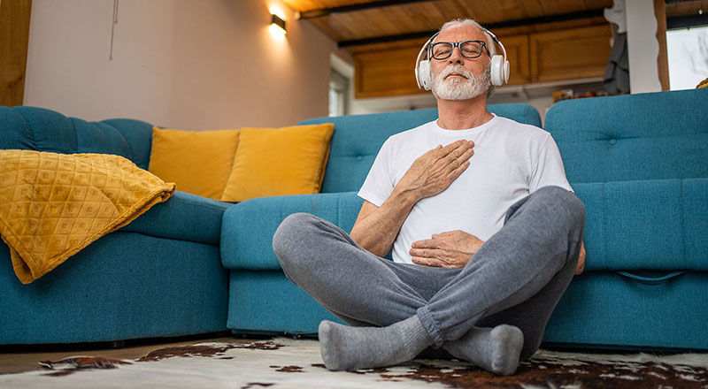 Man listening to music while sitting on the floor. 