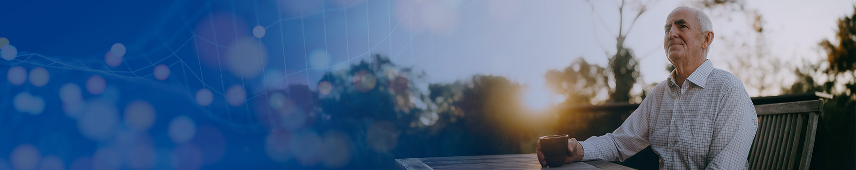 elderly man drinking coffee outdoors
