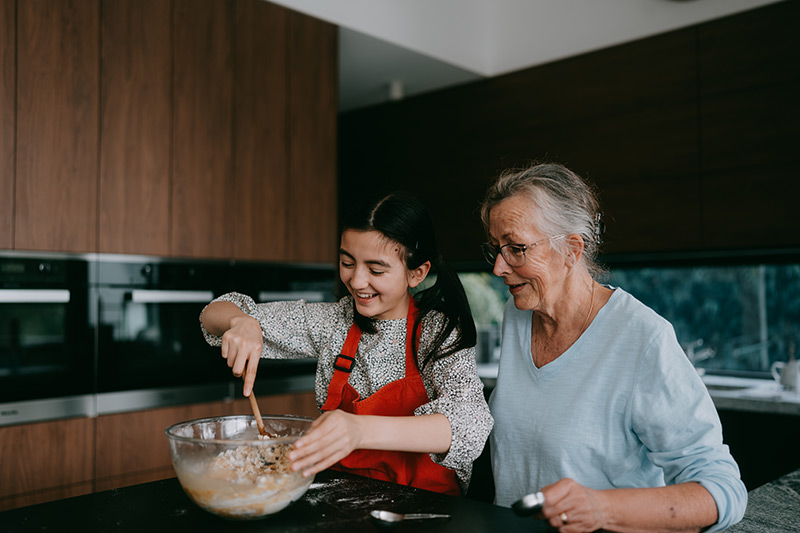 granddaughter baking with grandmother