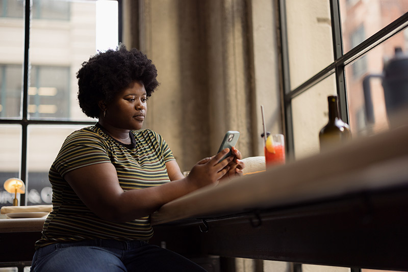 woman scrolling through cell phone