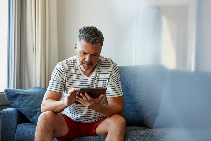 man browsing on his iPad