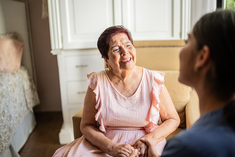older woman talking with her nurse