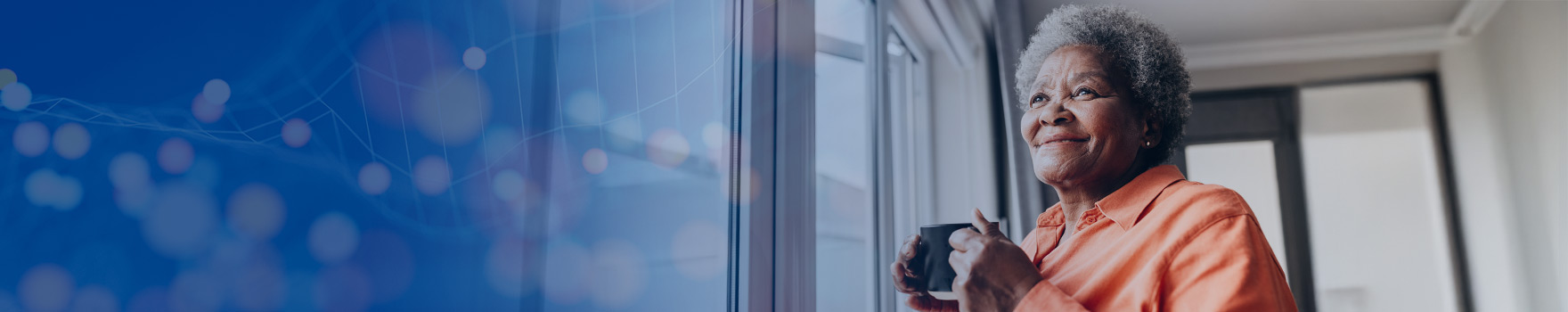 woman drinking coffee and looking out the window