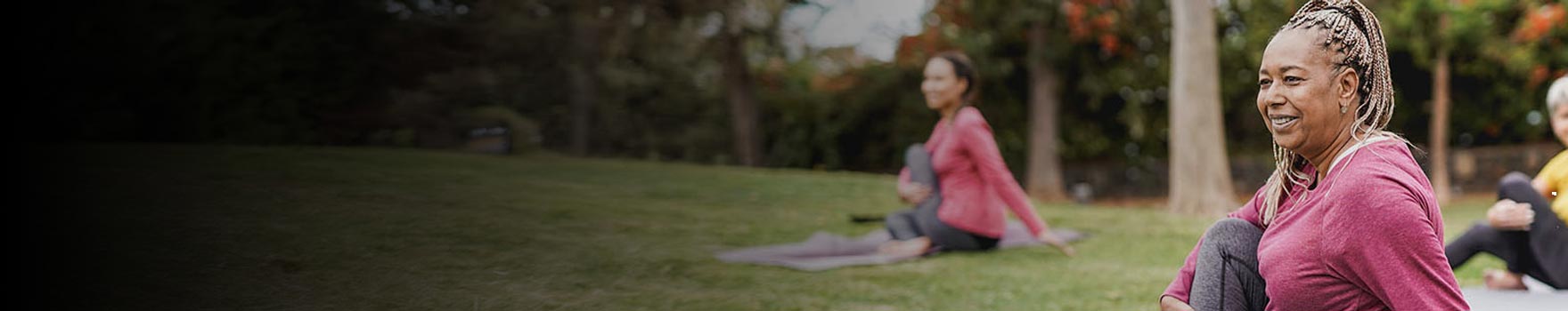 women doing yoga in a park